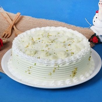 Half Kg Rasmalai Vanilla Cake garnished with Pista