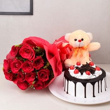 12 Red Roses in Paper Packing with Half Kg Black Forest Cake and Teddy bear (6 Inch)