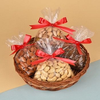 A Cane Basket containing Almonds (200 gms), Cashew Nuts (200 gms), Raisins (200 gms) and Pistachios (200 gms)
