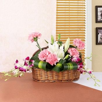 2 White Asiatic Lilies, 5 Pink Carnations, 4 Purple Orchids in Handle Basket