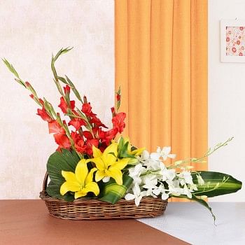 Floral Arrangement is the best gift ever. It has 3 Yellow Asiatic Lilies, 4 Red Glads and 3 White Orchids in a Basket