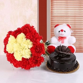 16 Carnations (Yellow and Red) in Yellow Raffia Knot with Chocolate Truffle Cake (Half Kg) and Teddy Bear (6inches)