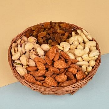 A Cane Basket containing Almonds (100 gms), Raisins (100 gms), Pistachios (100 gms) and Cashew Nuts (100 gms)