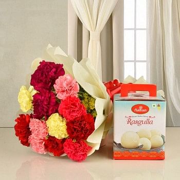 12 colorful carnations in white paper packing with 1 kg Haldiram rasgulla
