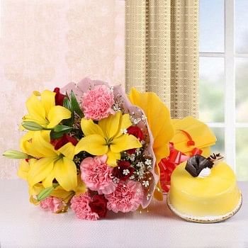 5 Yellow Asiatic Lilies and 8 Red Roses and 8 Pink Carnations in Pink and Yellow Paper with Mango Cake (Half Kg)