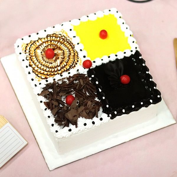 One Kg Square Shape 4 in 1 flavour cake such as Chocolate,Pineapple,Black Forest,Butterscotch