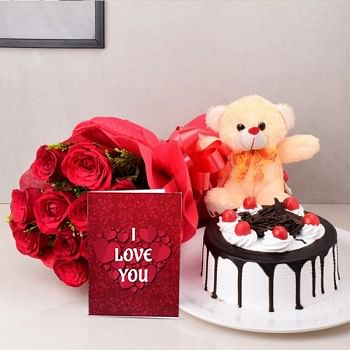 12 Red Roses in Paper Packing with Half Kg Black Forest Cake and Teddy bear (6 Inch) and Valentines Day Greeting Card