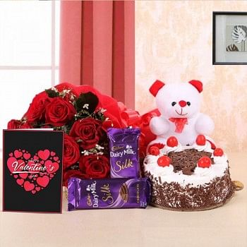 10 Red Roses in Paper Packing with 2 Cadbury's Dairy Milk Silks and Black Forest Cake (Half Kg) and 1 Teddy Bear (6 Inches) also a Valentines Day Greeting Card