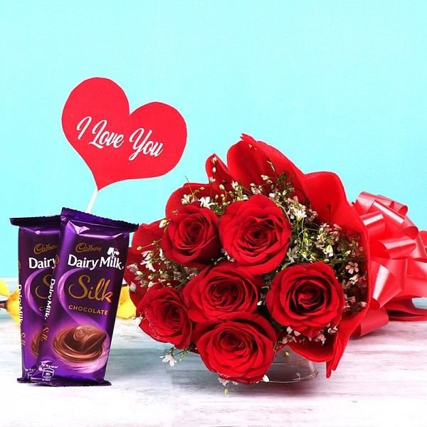 6 Red Roses in Paper Packing and 2 Dairy Milk Silk Chocolate (65 gm) with "I love you" Tag