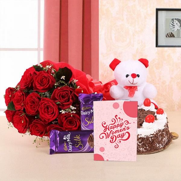 10 Red Roses in Paper Packing with 2 Cadbury's Dairy Milk Silks and Black Forest Cake (Half Kg) and 1 Teddy Bear (6 Inches) - Womens Day Greeting Card
